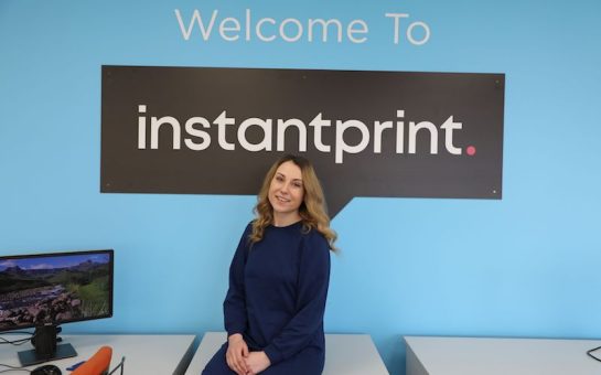 Head of Instantprint Laura Mucklow with a banner