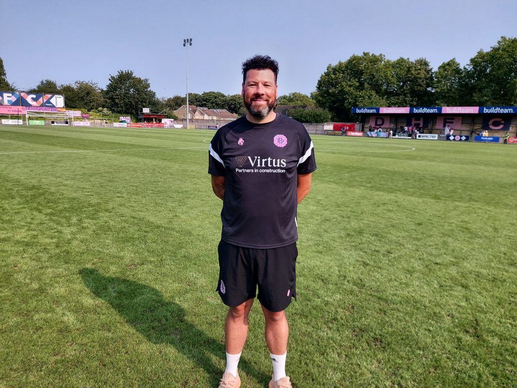 Dulwich Hamlet Women manager Ryan Dempsey standing on the Champion Hill pitch