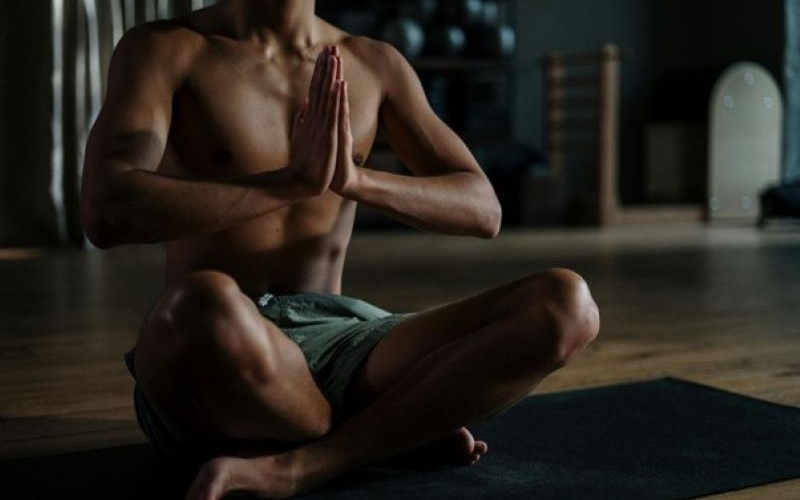 Muscular man doing yoga.