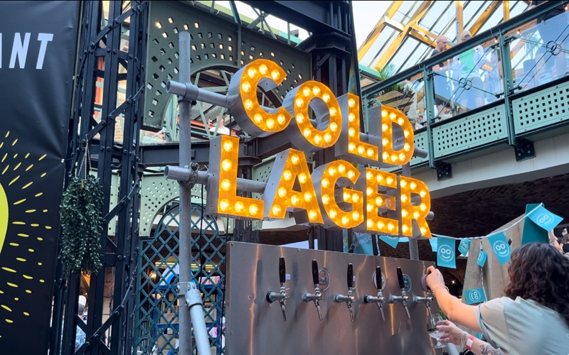 Sign saying 'cold lager' above beer taps