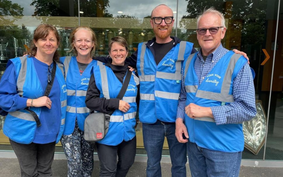 A group of community patrollers in high visibility jackets