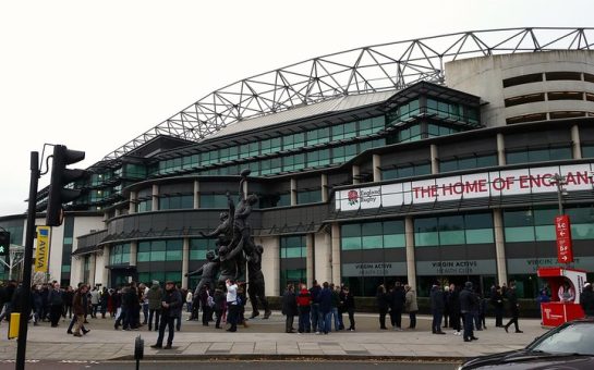 Photo outside twickenham stadium with the banner "home of rugby".