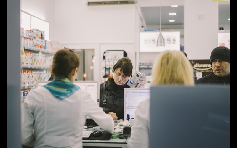 People getting served in a pharmacy.