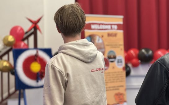 Teen boys play darts at chill out session