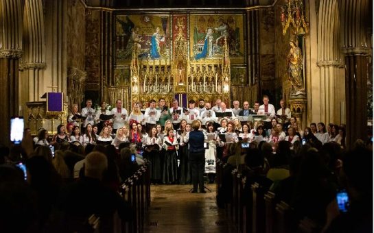 The Songs for Ukraine Chorus performing in front of an audience at Farm Street Catholic Church.