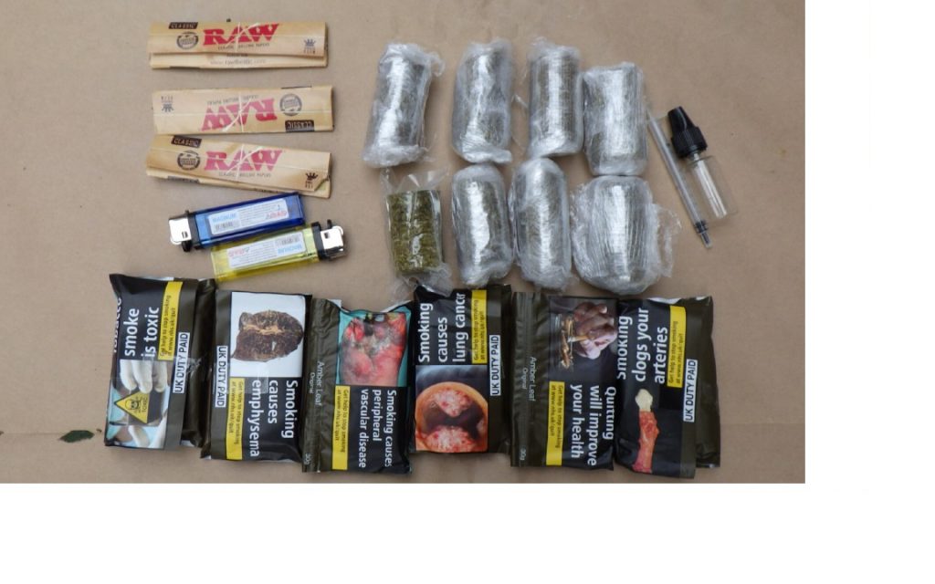 Drugs in bags, multiple packets of tobacco and lighters.